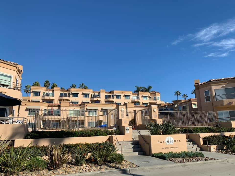 multiple tan stucco buildings that make up the San Miguel III condo complex